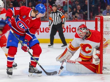 Canadiens' Christian Dvorak watches Calgary Flames goalie Jacob Markstrom make a save during first period of a National Hockey League game in Montreal Monday Dec. 12, 2022.