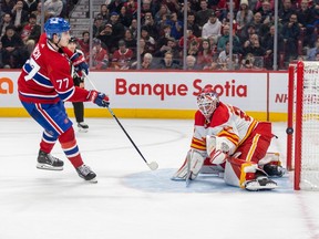 Canadiens' Kirby Dach shoots the puck past Calgary Flames Jacob Markstrom for the game winning goal during the shootout at the end of a National Hockey League game in Montreal Monday Dec. 12, 2022.