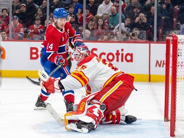 Canadiens Nick Suzuki shoots the puck past Calgary Flames Jacob Markstrom for shootout goal at the end of National Hockey League game in Montreal Monday Dec. 12, 2022.