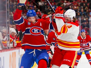 Canadiens' Josh Anderson and Calgary Flames' Connor Mackey bounce off each other during the first period of a National Hockey League game in Montreal Monday Dec. 12, 2022.