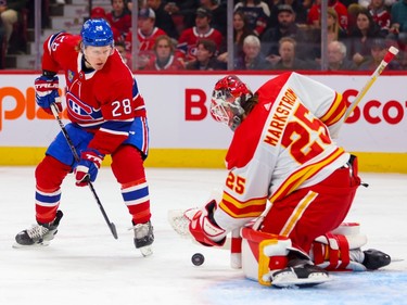 Canadiens' Christian Dvorak watches Calgary Flames goaltender Jacob Markstrom make a save during the first period of a National Hockey League game in Montreal Monday Dec. 12, 2022.