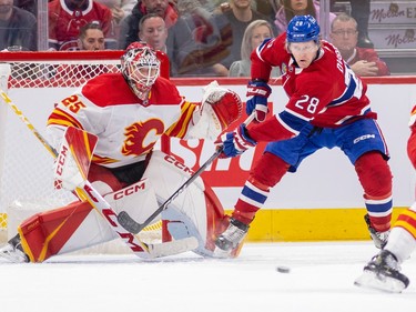 Canadiens' Christian Dvorak looks to tip the puck next to Calgary Flames' Jacob Markstrom during Habs power play in the second period of a National Hockey League game in Montreal Monday Dec. 12, 2022.