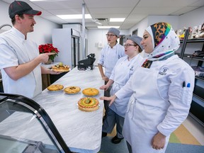 Chef/instructor Raphael Thuaux speaks with students Lin Lin Zhu, left, Anastazia Parlea and Norehane Ghorab in the bakery boutique at the Pearson School of Culinary Arts in Pointe-Claire.