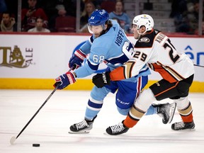 Anaheim Ducks defenceman Dmitry Kulikov (29) takes Montreal Canadiens left wing Mike Hoffman's (68) leg out from under him causing him to crash into Anaheim Ducks goaltender Lukas Dostal (1) during NHL action in Montreal, on Thursday, Dec. 15, 2022.