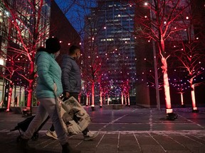 Montrealers walk by a Christmas light installation on Nov. 30, 2021
