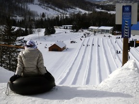 A rider waits at the top of a snow slide at Les Glissades des Pays d'en Haut.