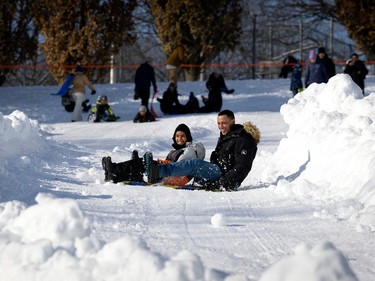 Jonathan and his son Leighton laugh as they gets sideways while tobogganing at King George Park in Westmount, on Thursday, December 29, 2022. The pair crashed out in the curve on the run.
