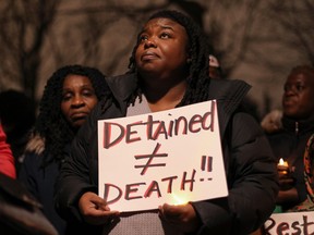 People attend a vigil for Nicous D'Andre Spring at Benny park in the Notre-Dame-de-Grâce area of Montreal Friday, December 30, 2022. D'Andre Spring, 21, died of his injuries following a "physical intervention" while he was detained at the Montreal Detention Centre on Dec. 24.