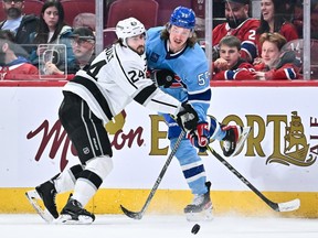 MONTREAL, CANADA - DECEMBER 10:  Los Angeles Kings' Phillip Danault (24) and Canadiens' Michael Pezzetta (55) skate against each other during the third period at the Bell Centre on Saturday, Dec. 10, 2022, in Montreal.