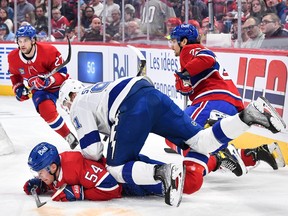 Tampa Bay Lightning's Steven Stamkos falls on top of Canadiens' Jordan Harris during the first period at the Bell Centre on Saturday, Dec. 17, 2022, in Montreal.