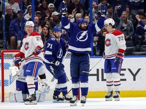 Alex Killorn #17 of the Tampa Bay Lightning celebrates his goal as Christian Dvorak #28 and Arber Xhekaj #72 of the Montreal Canadiens react during the first period at the Amalie Arena on December 28, 2022 in Tampa, Florida.
