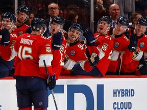 Teammates congratulate Aleksander Barkov #16 of the Florida Panthers after he scored his third goal of the first period against the Montreal Canadiens at the FLA Live Arena on Dec. 29, 2022 in Sunrise, Florida.