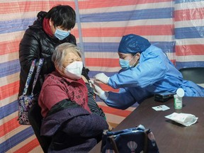 An elderly woman receives a COVID-19 vaccine in Shanghai on Dec. 15, 2022.