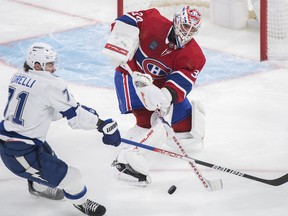 Canadiens goaltender Jake Allen clears the puck as Tampa Bay Lightning's Anthony Cirelli moves in during first period NHL hockey action in Montreal on Saturday, Dec.17, 2022.