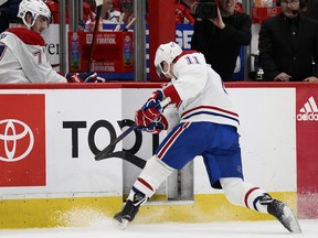 Canadiens'  Brendan Gallagher breaks his stick as he heads to the bench during the first period against the Washington Capitals on Saturday, Dec. 31, 2022, in Washington.