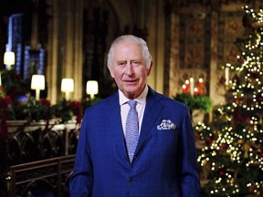 Britain's King Charles III delivers his message during the recording of his first Christmas broadcast in the Quire of St George's Chapel at Windsor Castle, Berkshire, England, Tuesday, Dec. 13, 2022.