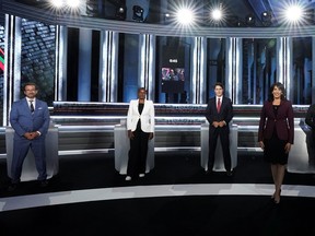 Moderator Shachi Kurl, right, poses for an official photo before the 2021 English-language federal leaders debate in Gatineau. Bloc Québécois Leader Yves-François Blanchet is at left.