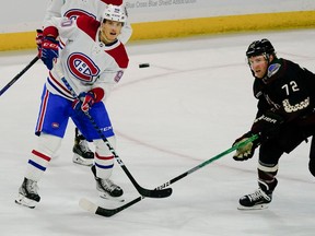 Montreal Canadiens' Anthony Richard (90) and Arizona Coyotes' Travis Boyd (72) keep their eye on the puck during the third period on Dec. 19, 2022, in Tempe, Ariz.