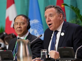 Quebec Premier Françcois Legault, right, sits alongside China Vice-Governor of Yunnan Province Wang Xiangang yesterday at the COP15 biodiversity conference in Montreal.