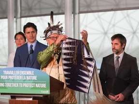 Elder Ka’nahsohon Kevin Deer performs a ceremony prior to Canada’s Prime Minister Justin Trudeau making an announcement supporting Indigenous-led conservation COP15 UN Biodiversity summit in Montreal on Wednesday.