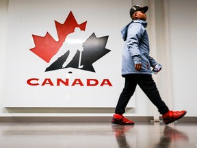 A person passes by a Hockey Canada logo at the organization's head office in Calgary, Alta., Sunday, Nov. 6, 2022. "The Hockey Canada scandal revealed the sport's toxic culture," Martine St-Victor writes.