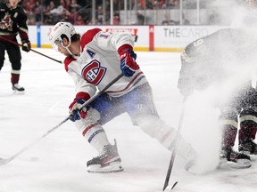 Canadiens forward Josh Anderson turns away from Arizona Coyotes defenceman J.J. Moser with the puck during first-period NHL action Monday night at Mullett Arena in Tempe, Ariz.