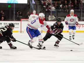 Canadiens right-wing Joel Armia moves the puck past Arizona Coyotes centre Nick Schmaltz during the first period at Mullett Arena in Tempe, Ariz.,
on Dec. 19, 2022.