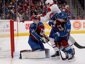 Canadiens centre Kirby Dach (77) attempts to deflect the puck against Colorado Avalanche goaltender Alexandar Georgiev (40) as centre Alex Newhook (18) defends in the first period at Ball Arena in Denver on Dec. 21, 2022.