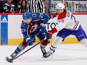 Avalanche right wing Logan O'Connor (25) and Montreal Canadiens defenceman Johnathan Kovacevic (26) battle for the puck in the first period at Ball Arena in Denver on Dec. 21, 2022.