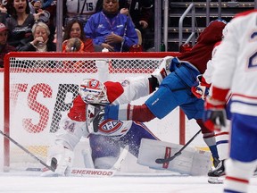 Montreal Canadiens goaltender Jake Allen makes a save against Colorado Avalanche centre Ben Meyers during the third period at Ball Arena in Denver on Dec. 21, 2022.