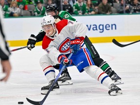 Canadiens' Jake Evans (71) skates with the puck past Dallas Stars defenceman Ryan Suter (20) during the first period at the American Airlines Center on Friday, Dec 23, 2022, in Dallas.