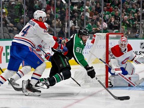 Canadiens' Joel Edmundson (44) checks Dallas Stars' Tyler Seguin (91) as goaltender Jake Allen defends the net during the second period at the American Airlines Center on Friday, Dec. 23, 2022, in Dallas.