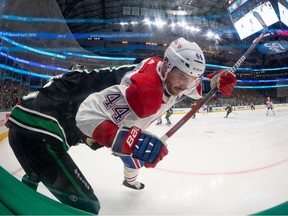 Dallas Stars' Jani Hakanpaa (2) checks Canadiens' Joel Edmundson (44) in the Stars zone during the third period at the American Airlines Center in Dallas on Friday, Dec. 23, 2022.
