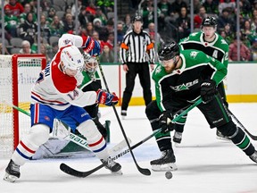Montreal Canadiens centre Nick Suzuki and Dallas Stars defenceman Jani Hakanpaa battle for control of the puck in the Stars' zone during the third period at the American Airlines Center in Dallas on Dec. 23, 2022.