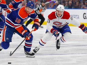Canadiens' Kaiden Guhle (21) chases Edmonton Oilers forward Zach Hyman (18) up the ice during the first period at Rogers Place in Edmonton on Saturday, Dec. 3, 2022.