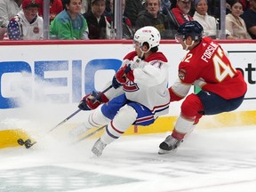 Canadiens centre Jake Evans (71) and Florida Panthers defenceman Gustav Forsling (42) battle for the puck during the first period at FLA Live Arena in Sunrise, Fla., on Dec. 29, 2022.