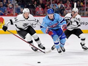 Canadiens forward Cole Caufield (22) chases the puck against Los Angeles Kings defenceman Mikey Anderson (44) and forward Blake Lizotte (46) during the second period at the Bell Centre  on Saturday, Dec. 11, 2020, in Montreal.