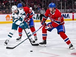 San Jose Sharks defenceman Erik Karlsson battles for the puck with Montreal Canadiens centre Sean Monahan (91) during the second period at Bell Centre in Montreal on Nov. 29, 2022.