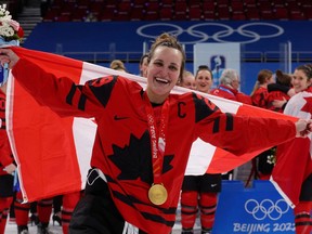Marie-Philip Poulin of Canada celebrates with her gold medal at the Beijing Olympics on Feb. 17, 2022.