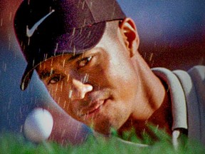 Tiger Woods hits out of a bunker while playing in the Canadian Open at Royal Montreal Golf Club in 1997.  He shot 76 and missed the cut for the first time in his PGA career.