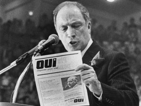 Canadian Prime Minister Pierre Elliott Trudeau reads Oui manifest during a No rally at Paul Sauvé Arena in Montreal on May 14, 1980.