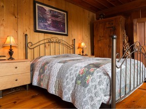 In the master bedroom, the bronze headboard and footboard have thin metal rods that look antique.