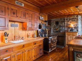 As a nod to the simple designs of the past, the kitchen has been remodeled with pine cabinets with branches the size of a porthole.