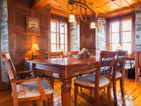 A striking architectural element are wooden panels that partially cover the thick stone walls.