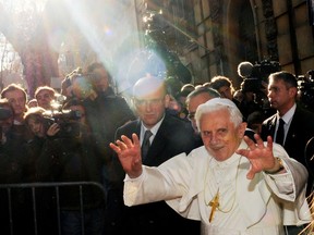 Pope Benedict XVI waves to the faithful at the end of his visit to the canteen of Sant'Egidio Community in Rome, Italy December 27, 2009.