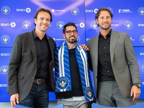 CF Montréal president and chief executive officer Gabriel Gervais, left, and chief sporting officer Olivier Renard, flank the team's new head coach, Hernán Losada, following a news conference in Montreal on Dec. 22, 2022.