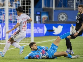 CF Montréal goalkeeper James Pantemis makes a save against New York Red Bulls' Omir Fernandez during second half MLS soccer action in Montreal, Wednesday, Aug. 31, 2022. Montreal has signed Pantemis to a new contract for the 2023 season, with option years in 2024 and 2025.
