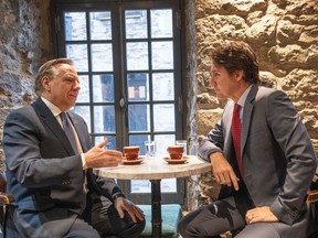 Prime Minister Justin Trudeau and Premier François Legault chat over coffee in Montreal, on Tuesday, Dec. 20, 2022.