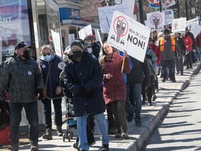 Protesters walk along the streets of east-end Montreal on April 2, 2022, to show their opposition to the plan to develop the REM de l'Est.