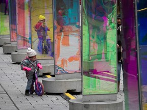 Three year-old Jasmine Ait Aoudia  gets a closer look at the Prismatica  art show at Place des Festivals while riding her bicycle Jan. 3, 2023.